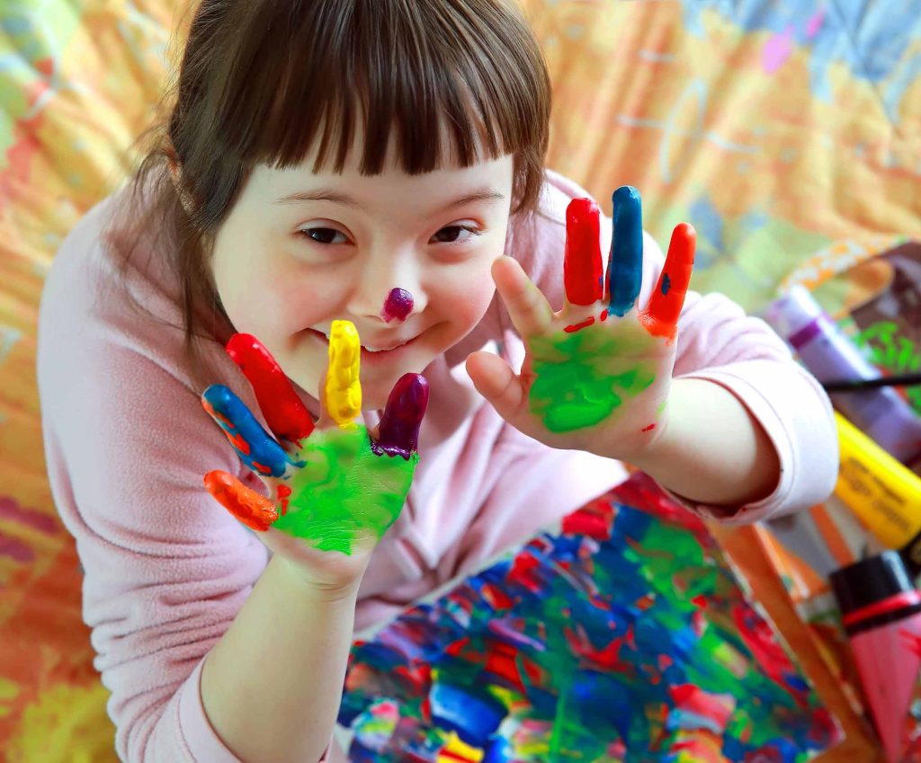 Girl with special needs hand painting